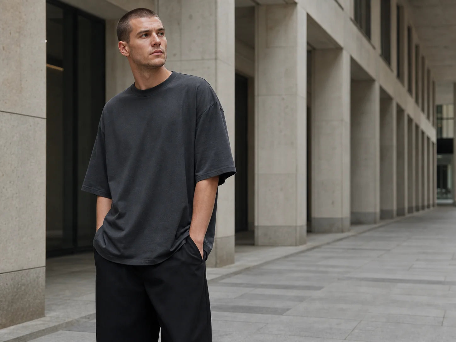 Model wearing a charcoal T-shirt